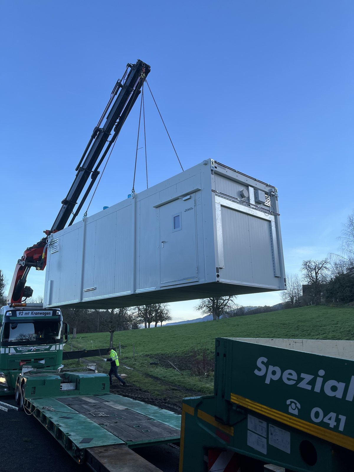 A smolsys radio-isotope container laboratory being lifted into place by a mobile crane
